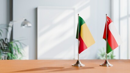 Obraz premium FLAGS OF BENIN AND OMAN ON TABLE