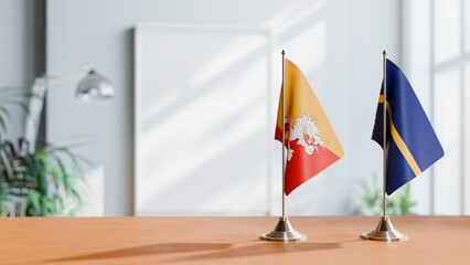 FLAGS OF BHUTAN AND NAURU ON TABLE