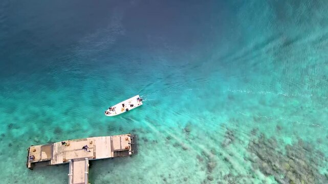 Boat Filled with Passengers Docked at a Small Pier