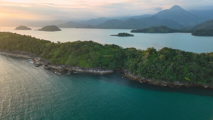 Aerial view of picturesque islands and serene sea with lush mountains and tropical forest, Paraty, Brazil.
