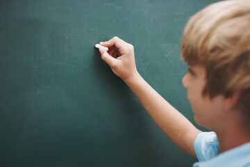 Student, boy and writing on chalkboard in classroom with problem solving, education or learning development. Scholarship, child and answer question with mockup space, studying or assessment at school