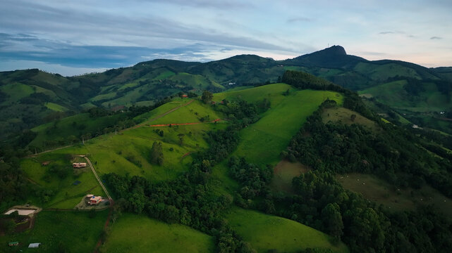 Aerial view of lush green hills and serene mountains in a picturesque valley, Monte Verde, Minas Gerais, Brazil.
