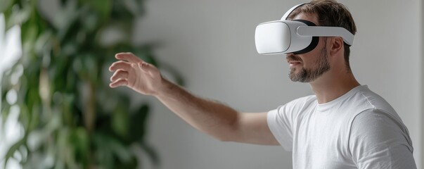 A man experiences virtual reality using a headset, reaching out as he engages with the immersive digital environment.