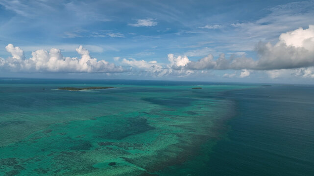 Aerial view of beautiful reef and clouds over the ocean, Manuka, Tonga.