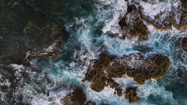 Aerial view of tropical island reef with azure ocean waves, Utulau, Tonga.
