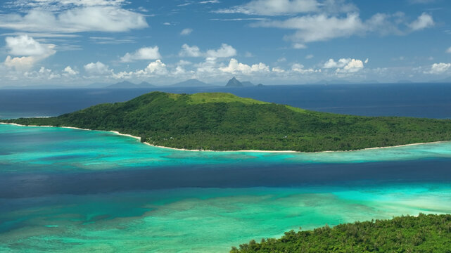 Aerial view of a tropical paradise island with a serene lagoon and lush palms, Shefa, Vanuatu.