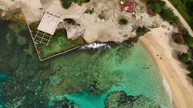 Aerial view of a beautiful tropical island with clear water, sandy beach, and lush palms, Shefa, Vanuatu.