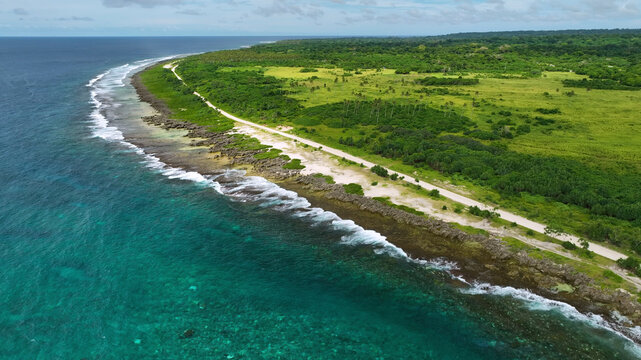 Aerial view of a tropical island with turquoise waters, pristine reef, and lush greenery, Shefa, Vanuatu.