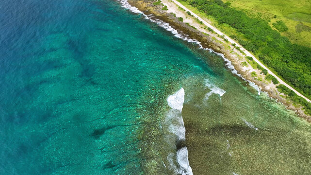 Aerial view of a beautiful tropical island with turquoise water and crashing waves, Shefa, Vanuatu.