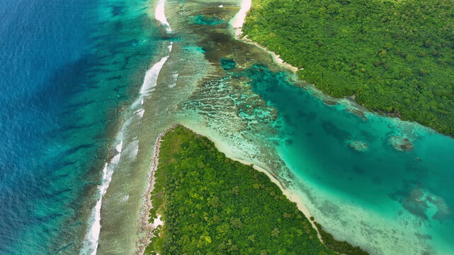 Aerial view of vibrant reef and serene waves in the blue ocean, Eton, Vanuatu.