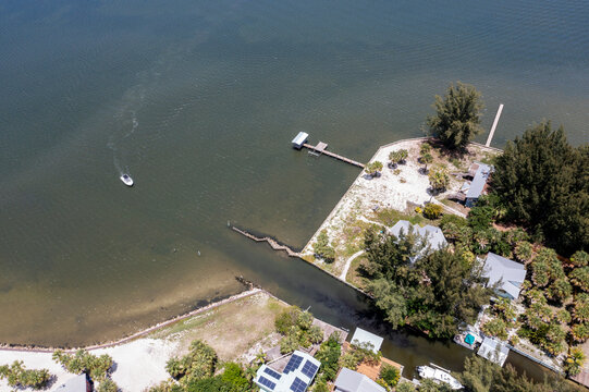 Aerial view of Grant Farm Island in the serene Indian River Lagoon with beautiful homes and lush greenery, Grant Valkaria, Florida, United States.