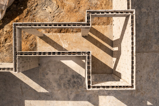 Aerial view of new home construction site with foundation and building blocks, Vero Lake Estates, United States.