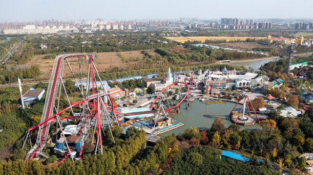 Aerial view of Songjiang Sheshan Hill amusement park with roller coasters and a pond, Songjiang District, People's Republic of China.