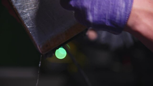 Applying Ski Wax To Ski Base with iron. Ski base tuning and paraffin bars. skiing service repair. repairman in workshop ski service. Man Waxing In Workshop