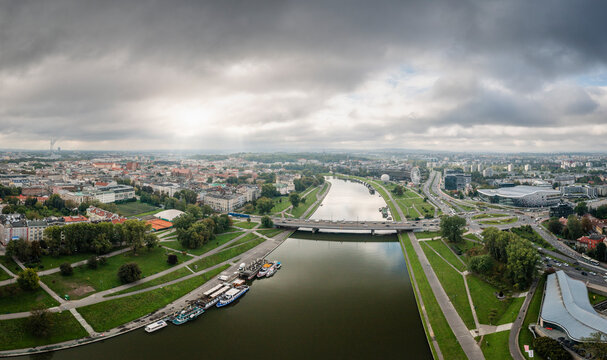 Aerial view of beautiful cityscape with Vistula river, bridge, and park, Krakow, Poland.