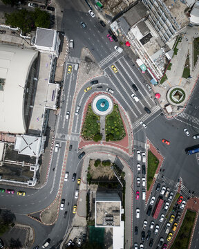 Aerial view of a busy roundabout with vehicles and modern buildings, Pathum Wan, Thailand.