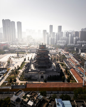Aerial view of gui yuan temple surrounded by modern skyscrapers in a bustling cityscape, wuhan, china.