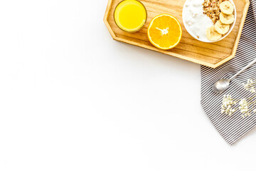 Healthy granola and orange juice for colorful breakfast on white background top view mock-up