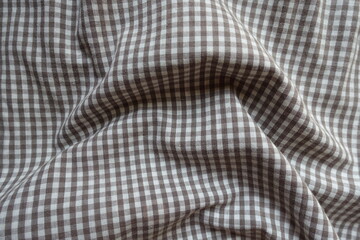 Crumpled cotton fabric with grey and white gingham pattern