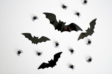 Halloween decorations in the form of spiders and bats on a white background