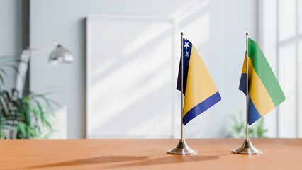 FLAGS OF BOSNIA AND GABON ON TABLE