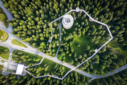 Aerial view of a serene hiking trail winding through a lush forest in Pohorje, Rogla, Slovenia.