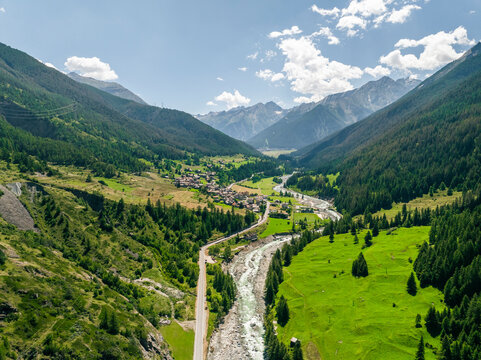 Aerial view of beautiful alpine landscape with mountains, lush valley, and a serene village, Cogne, Italy.