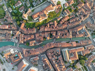 Aerial view of picturesque Vieille Ville with charming stone buildings and red roofs alongside a scenic canal, Annecy, France.