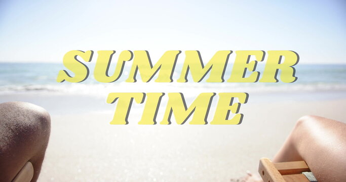 Image of summer time text over diverse couple holding hands on beach