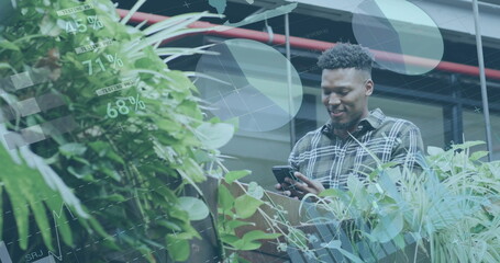 Image of financial data processing over biracial businessman in office