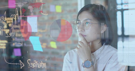 Image of financial data processing over biracial businesswoman in office