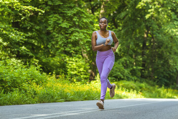 Woman, runner and fitness on mountain with music for wellness workout or cardio training with audio motivation. Black woman, athlete and listening or streaming radio podcast, sports running outdoor.