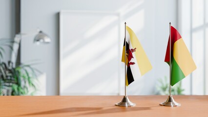 FLAGS OF BRUNEI AND GUINEA-BISSAU ON TABLE