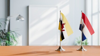 FLAGS OF BRUNEI AND PARAGUAY ON TABLE