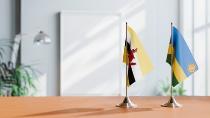 FLAGS OF BRUNEI AND RWANDA ON TABLE