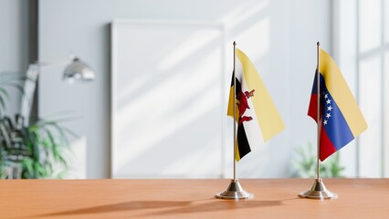 FLAGS OF BRUNEI AND VENEZUELA ON TABLE