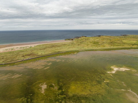 Aerial view of holy island at low tide with beautiful coastline and green landscape, Berwick-upon-Tweed, United Kingdom.