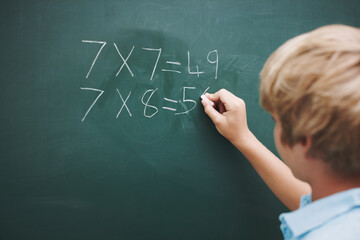 Math, boy and writing on chalkboard in classroom with problem solving, education or learning equation. Scholarship, student and answer question with multiplication solution or number lesson on mockup