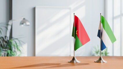 FLAGS OF BURKINA-FASO AND SIERRA LEONE ON TABLE