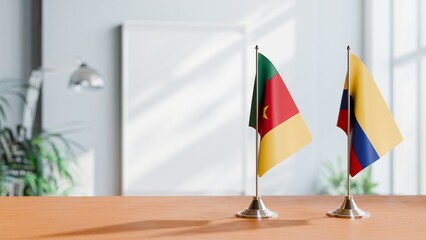 FLAGS OF CAMEROON AND COLOMBIA ON TABLE