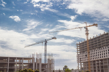 Unfinished construction. Two buildings and two tower cranes.