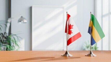 FLAGS OF CANADA AND GABON ON TABLE