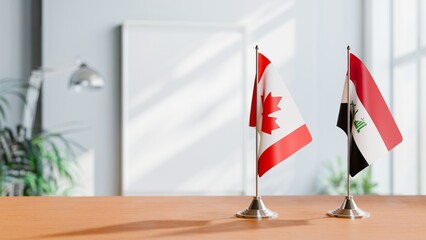 FLAGS OF CANADA AND IRAQ ON TABLE