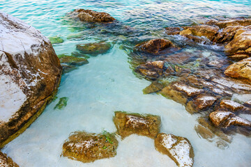 A rocky shoreline with a body of water in front of it