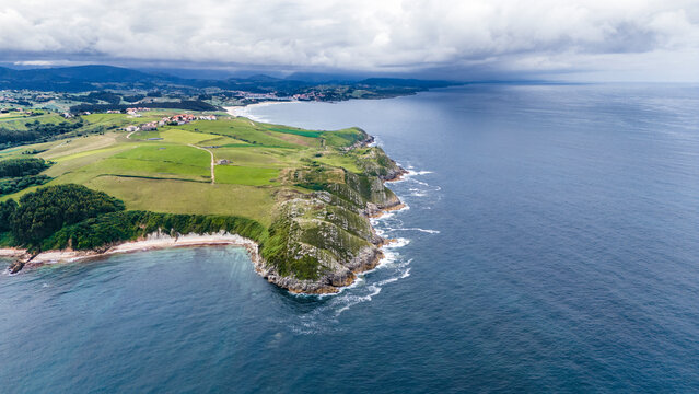 Aerial drone view of the coastline of North Spain near Playa Oyambre at the Cantabrian Sea, San Vincente, Spain