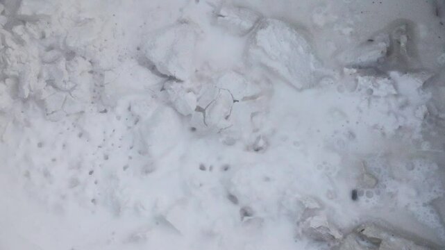 chemical reaction calcium hydroxide during lime slaking in water close-up 4k video