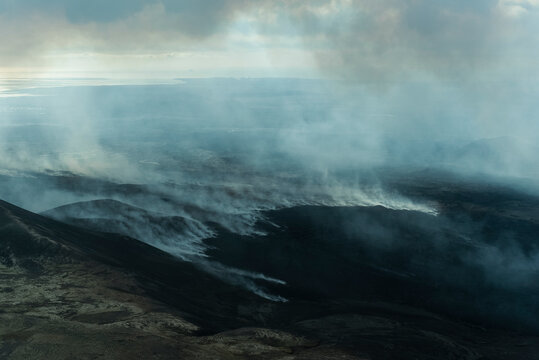 Aerial view of majestic Fagradalsfjall volcano with smoke and clouds over beautiful landscape, Grindavik, Iceland.