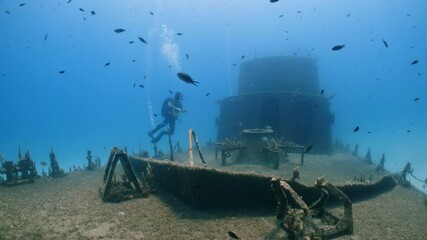 Underwater shot of SCUBA Diver swimming over the P31 wreck in Malta