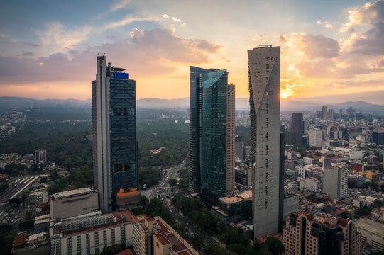 Aerial view of sunset skyline with skyscrapers and Bosque de Chapultepec park, Cuauhtemoc, Mexico.