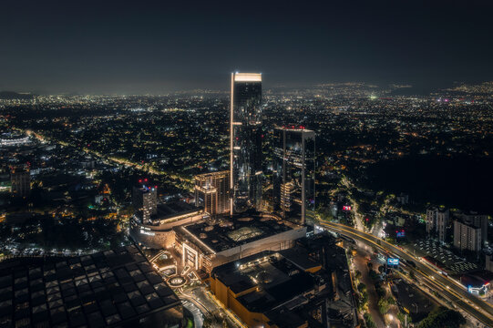 Aerial view of mitikah tower illuminated at night with a vibrant cityscape and bustling urban life, benito juarez, mexico.